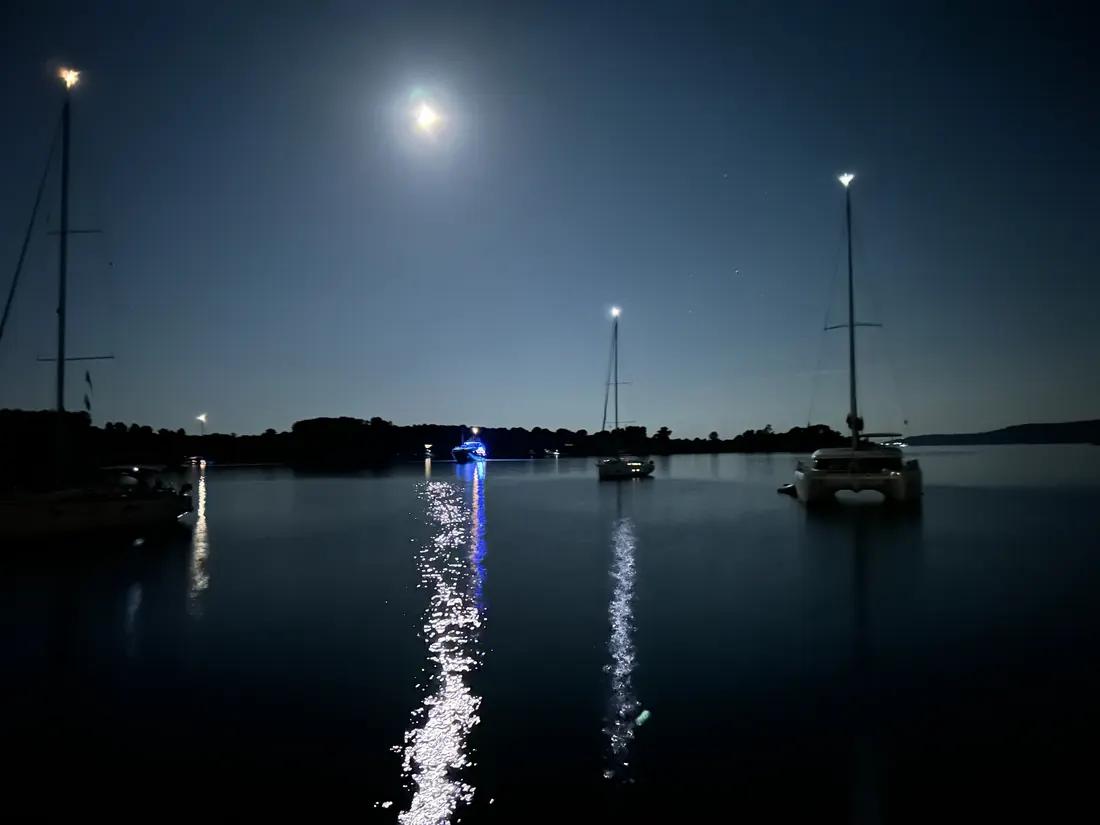 Moonlit anchorage with boats at rest