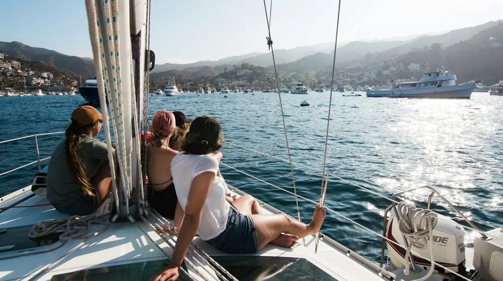 Small group relaxing on the bow of a sailboat